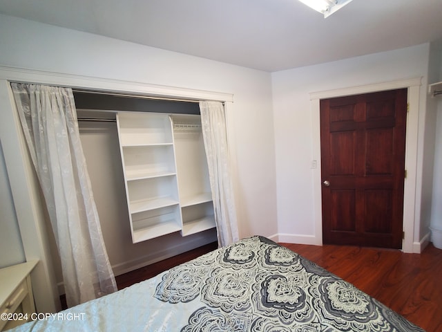 bedroom with a closet and dark hardwood / wood-style floors