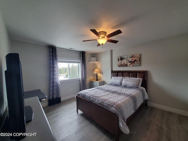 bedroom with ceiling fan and hardwood / wood-style flooring