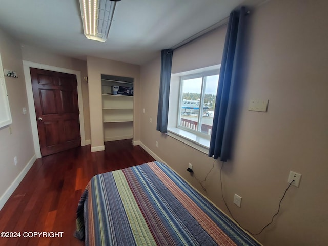 unfurnished bedroom featuring a closet and dark hardwood / wood-style floors