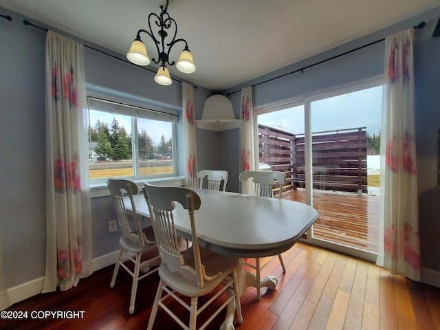 dining area featuring a notable chandelier and hardwood / wood-style flooring