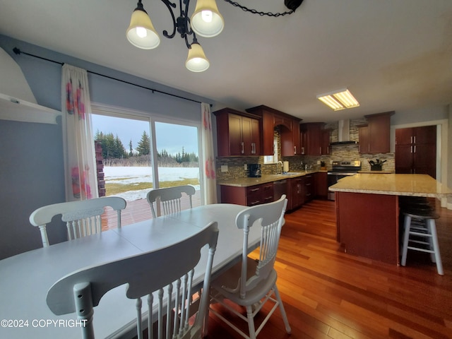 dining room featuring sink, dark hardwood / wood-style flooring, and a water view