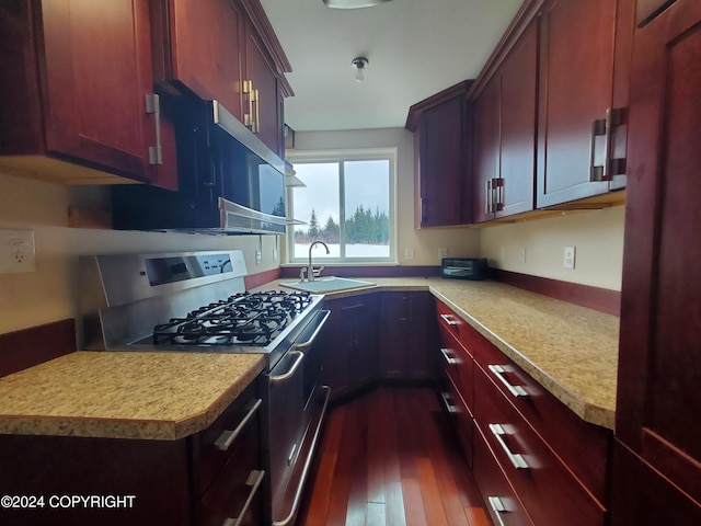 kitchen featuring sink, dark hardwood / wood-style flooring, and stainless steel gas stove