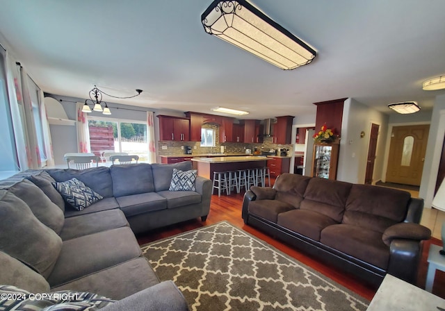 living room featuring dark hardwood / wood-style flooring and an inviting chandelier