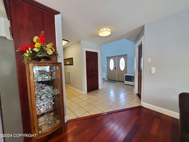 entrance foyer featuring french doors and light tile patterned floors