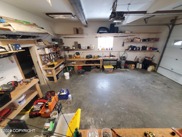 garage with a workshop area and a garage door opener