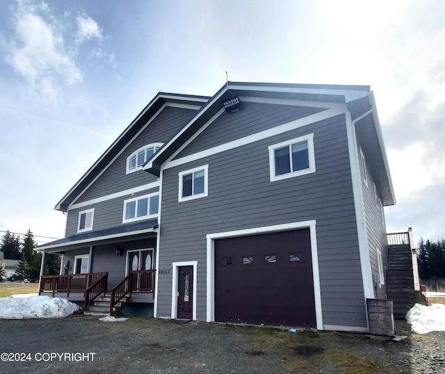 view of front facade with covered porch and a garage