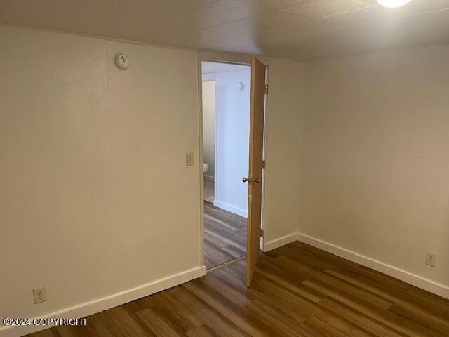 empty room with dark hardwood / wood-style floors