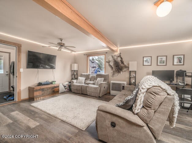 living room featuring beamed ceiling, dark hardwood / wood-style floors, and ceiling fan