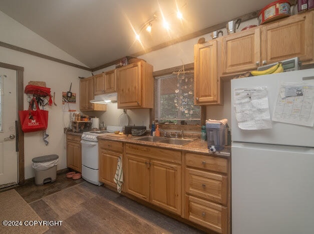 kitchen with lofted ceiling, white appliances, sink, and dark wood-type flooring