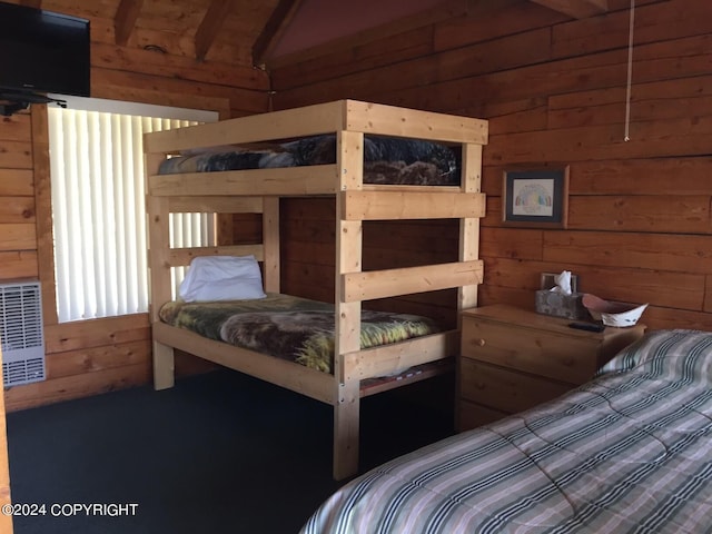 bedroom featuring wood walls and vaulted ceiling with beams