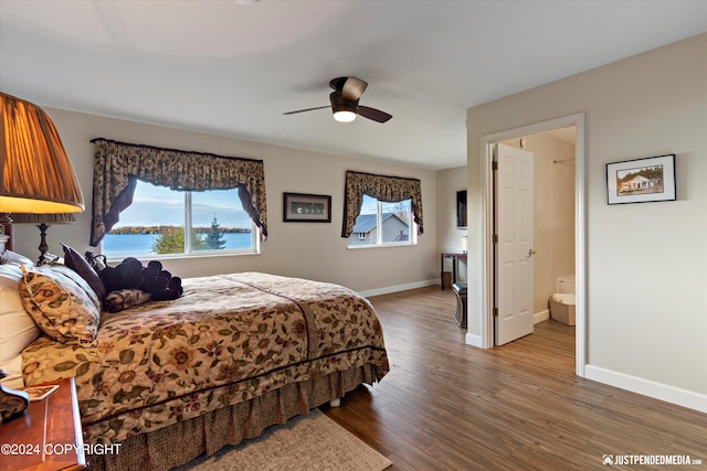 bedroom with connected bathroom, hardwood / wood-style floors, and ceiling fan