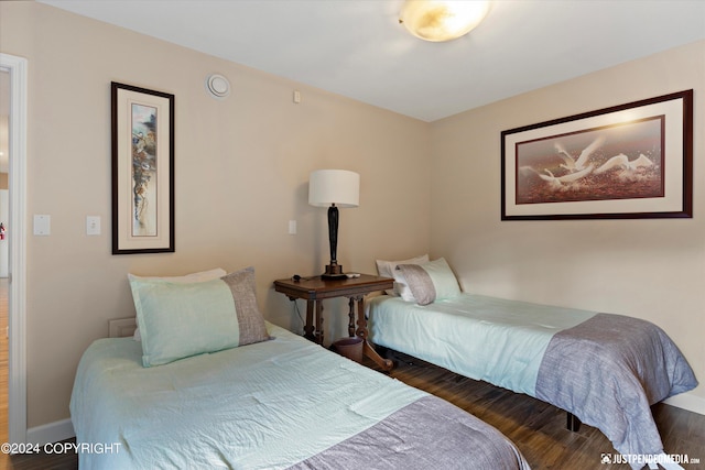 bedroom with dark hardwood / wood-style floors