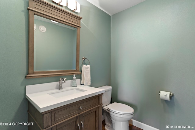 bathroom with toilet and vanity