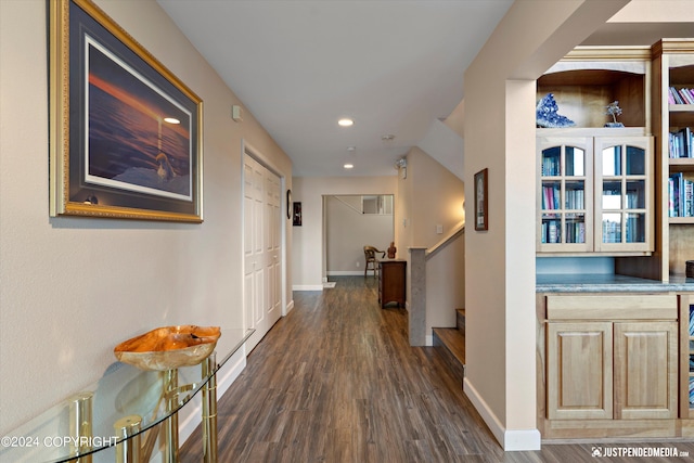 corridor with dark hardwood / wood-style flooring