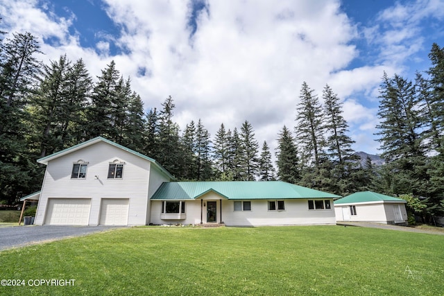 view of front of property with a front lawn and a garage