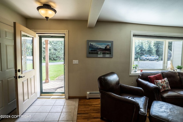 foyer with a baseboard heating unit and tile floors