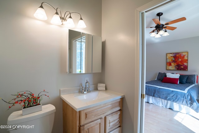 bathroom with ceiling fan, vanity, and toilet