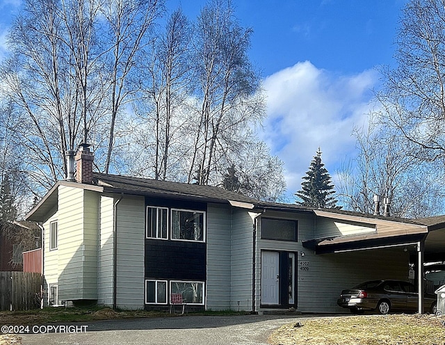 raised ranch featuring a carport