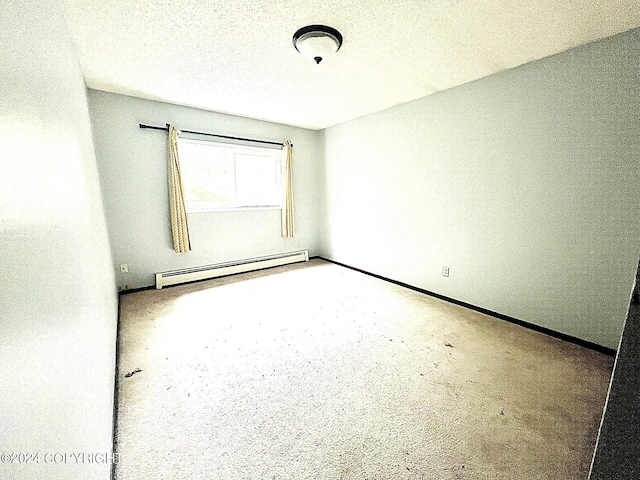 unfurnished room featuring a textured ceiling and baseboard heating