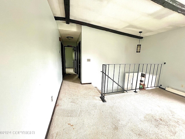 interior space featuring light colored carpet and beamed ceiling