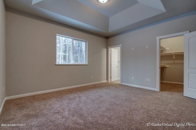 L7 Harman Loop, Wasilla, AK 99654 - unfurnished bedroom featuring a closet, a spacious closet, carpet floors, and a raised ceiling