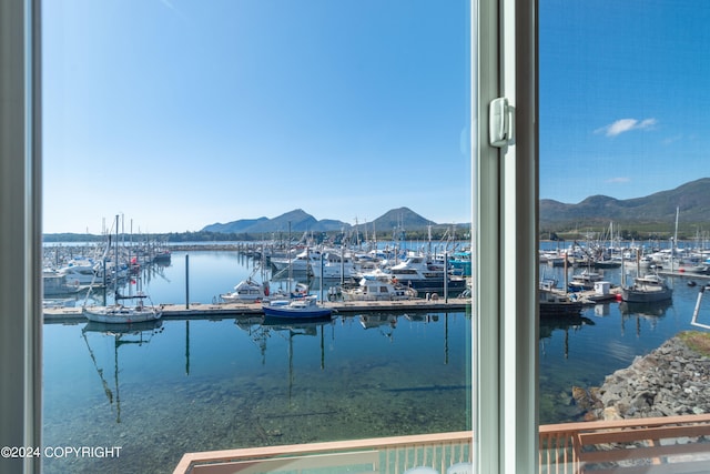 property view of water featuring a mountain view and a dock