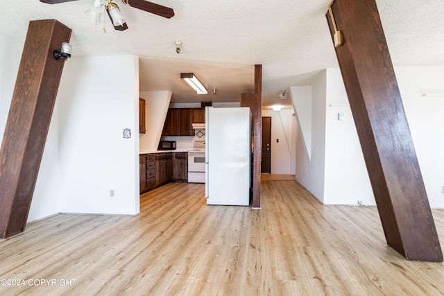 kitchen featuring white appliances, ceiling fan, light wood-type flooring, and a textured ceiling