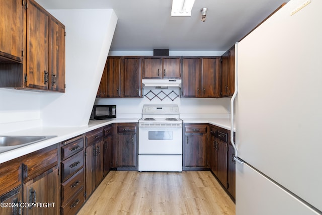 kitchen featuring dark brown cabinetry, white appliances, tasteful backsplash, and light wood-type flooring