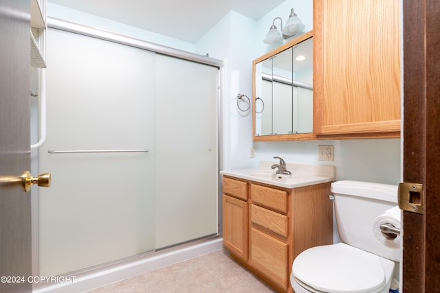 bathroom with walk in shower, vanity with extensive cabinet space, toilet, and tile flooring