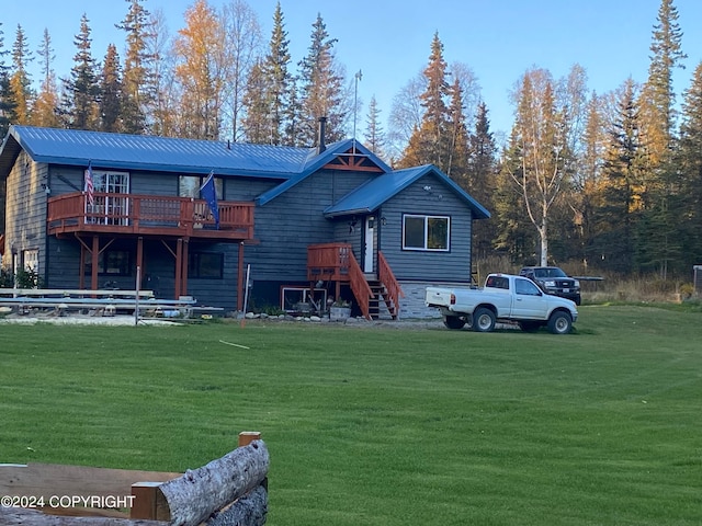 view of front of house with a front yard and a wooden deck