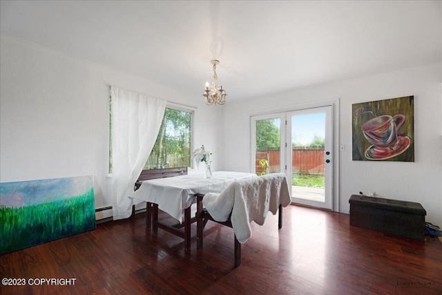 dining room with a chandelier, hardwood / wood-style flooring, and baseboard heating