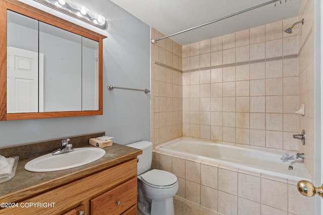 full bathroom with tiled shower / bath combo, vanity, and toilet