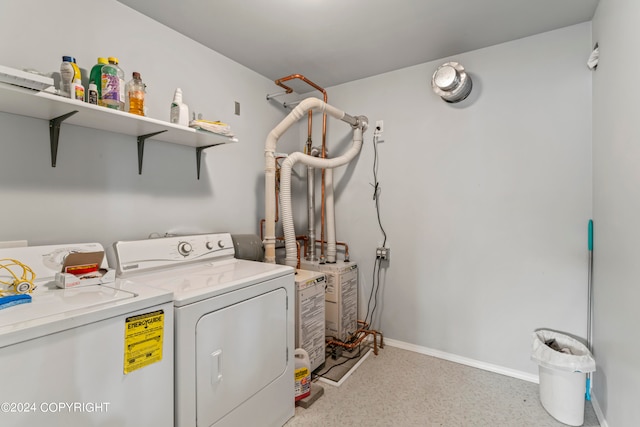 clothes washing area with washer and clothes dryer