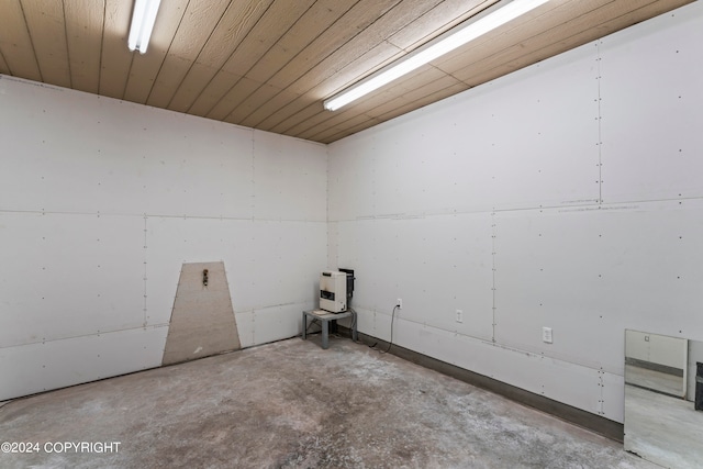 unfurnished room with concrete floors and wooden ceiling