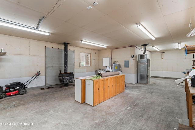 basement featuring a wood stove and water heater