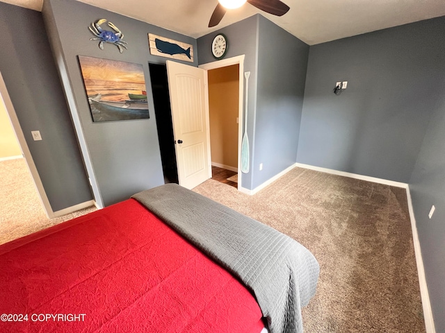 carpeted bedroom with ceiling fan and baseboards