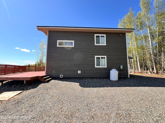 view of side of home featuring a wooden deck