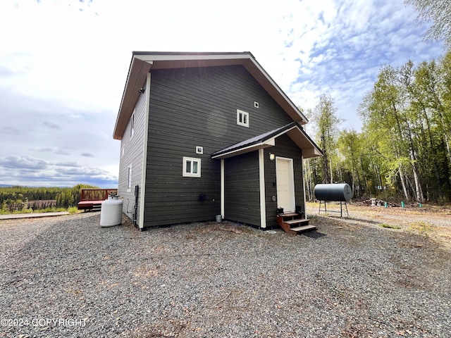 back of house with entry steps and heating fuel