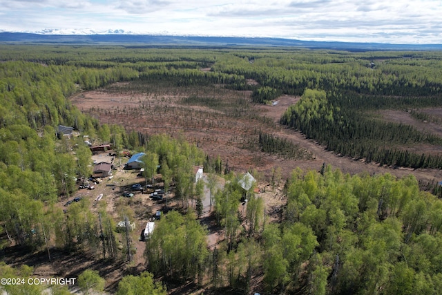 birds eye view of property with a forest view