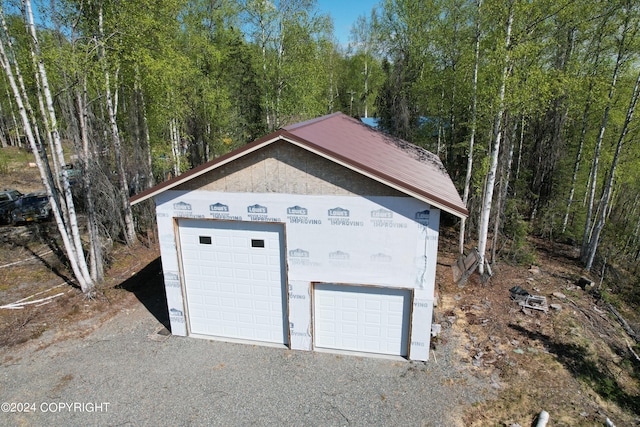 garage featuring a view of trees