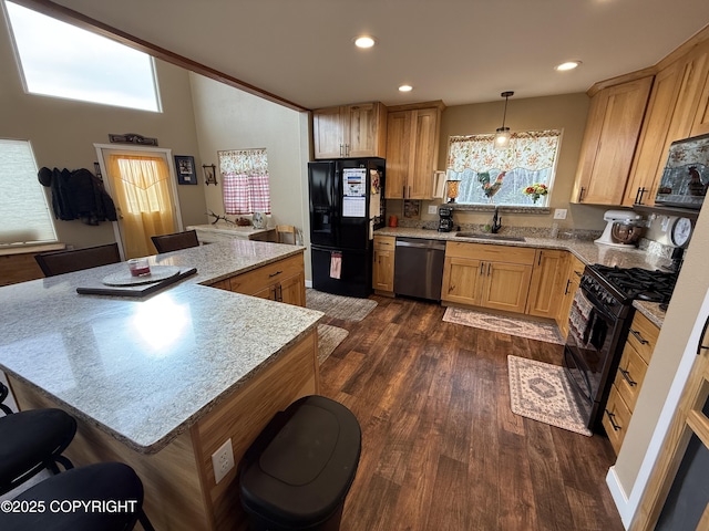 kitchen with recessed lighting, dark wood-style flooring, a sink, and black appliances