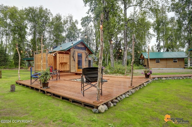 wooden terrace featuring a yard