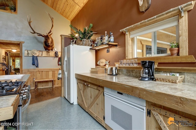 kitchen with white appliances, tile counters, wood ceiling, high vaulted ceiling, and a sink