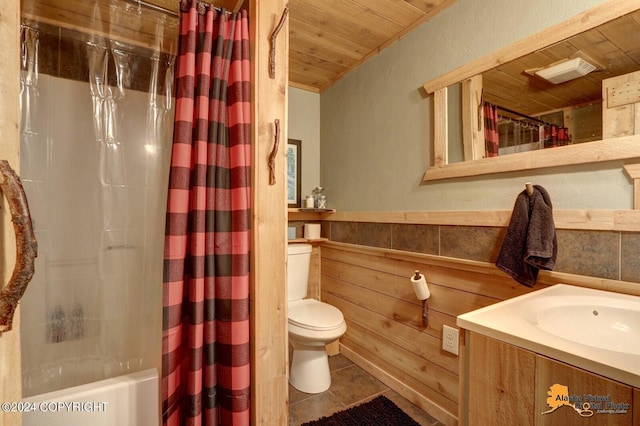 bathroom with toilet, wooden ceiling, a wainscoted wall, tile patterned floors, and vanity