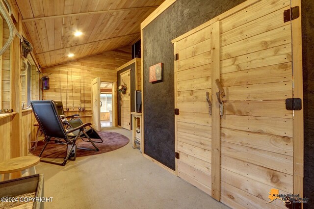 interior space with lofted ceiling, wooden ceiling, and wood walls