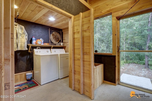 laundry area with independent washer and dryer, wooden ceiling, and wooden walls