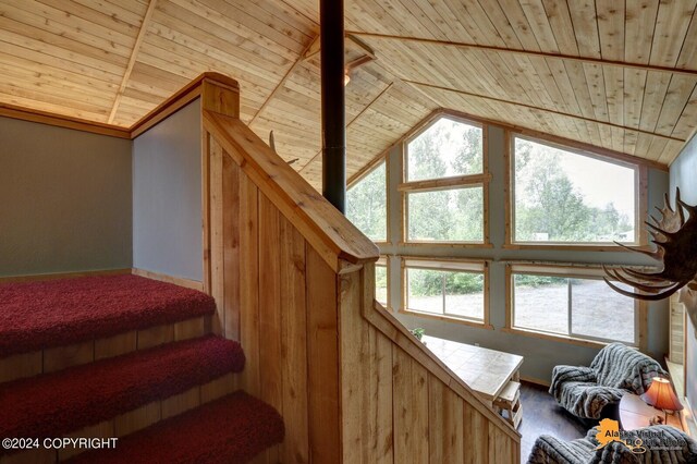 stairway with hardwood / wood-style flooring, wooden ceiling, and vaulted ceiling