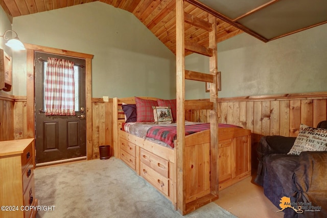 carpeted bedroom featuring vaulted ceiling, wood walls, wainscoting, and wooden ceiling