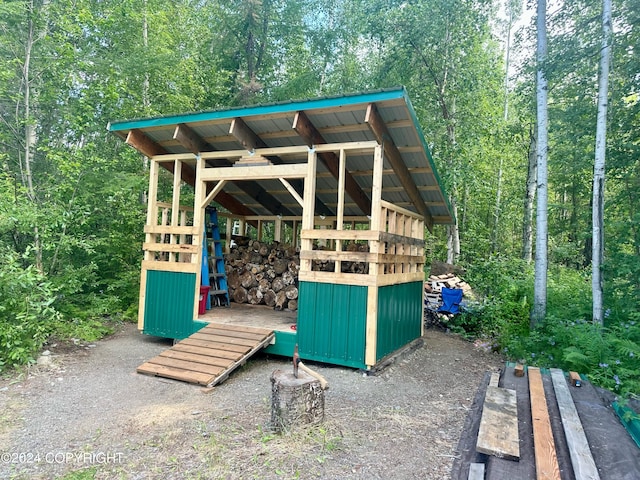 view of outbuilding with an outbuilding and a forest view