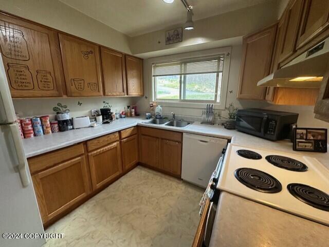 kitchen featuring sink and white appliances